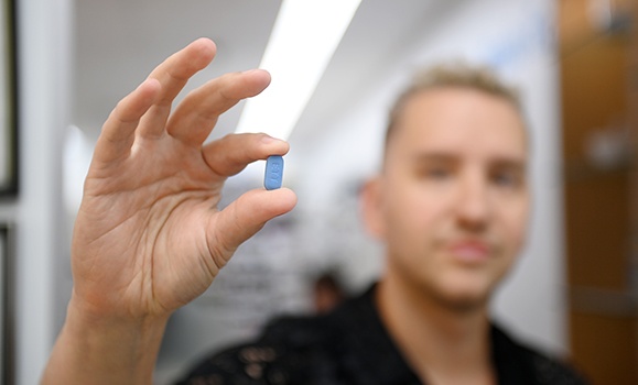 Dale Lemieux, a participant in the PrEP prescription study, holds one of the HIV prevention drugs. 